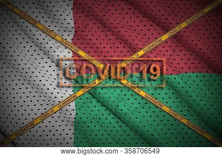 Madagascar Flag And Covid-19 Stamp With Orange Quarantine Border Tape Cross. Coronavirus Or 2019-nco