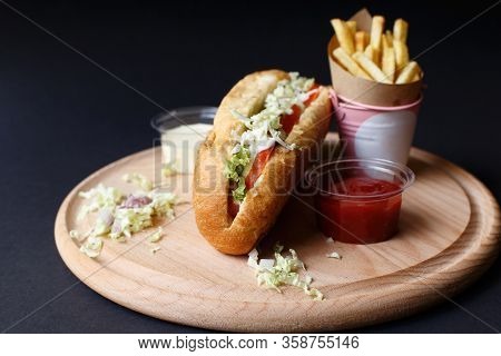 Hot Dogs With French Fries And Ketchup On Wooden Plate.