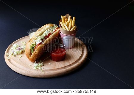 Hot Dogs With French Fries And Ketchup On Wooden Plate.