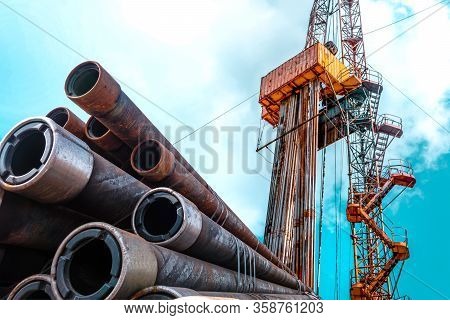 Oil And Gas Drilling Rig Onshore Dessert With Dramatic Cloudscape. Oil Drilling Rig Operation On The