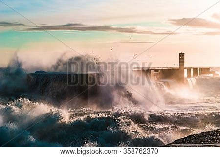 Waves Crashing On A Pier At Sunset, Porto, Portugal, Nov.2019