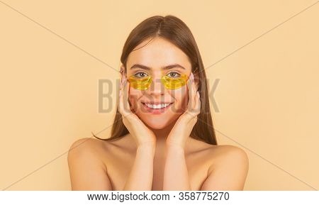 Woman Applying Golden Eye Patches. Close Up Portrait Girl. Portrait Of Beauty Woman With Eye Patches