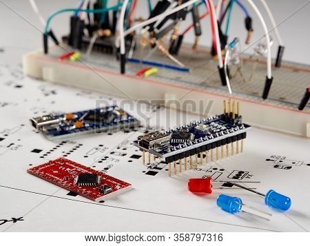 Arduino And Programmers With Peripherals And Expansion Boards Lie On A Gray Background. Do It Yourse