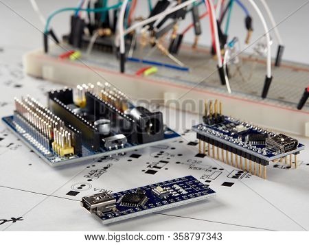 Arduino And Programmers With Peripherals And Expansion Boards Lie On A Gray Background. Do It Yourse