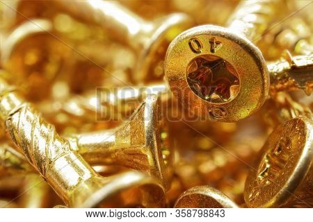 Torx Screws Close Up. Gold Screws For Wood, Chipboard Or Plywood With Torx Head. Soft Focus