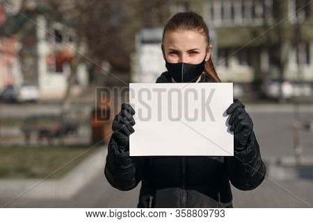 Covid-19 Pandemic Coronavirus. A Doctor With A Paper With Keep Calm And Stay At Home Holding On Hand