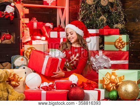 Cheerful Santa Helper Sort Presents. Smiling Shop Assistant. Kid In Santa Hat With Many Gift Boxes. 