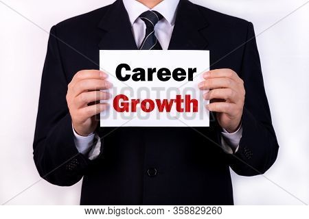 Businessman Holding A Card With Text Career Growth