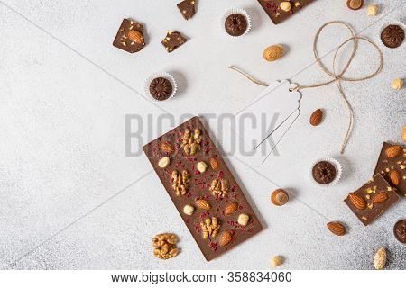 Milk Chocolate Bar With Nuts And Chocolate Candies On White Background. Homemade Organic Chocolate. 
