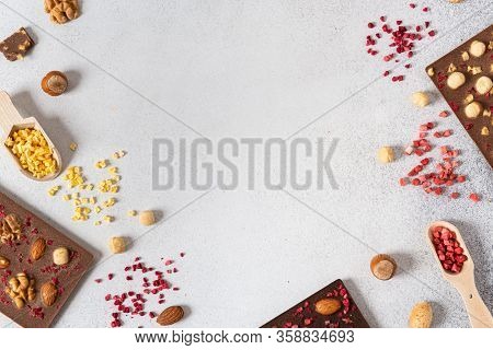 Dark And Milk Chocolate Bars With Nuts And Dried Fruits On Light Background. Homemade Organic Chocol