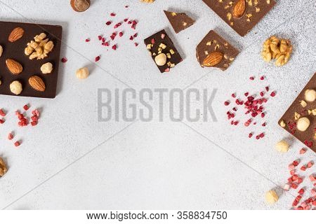 Milk And Dark Chocolate Bars With Nuts And Dried Fruits Chocolate Candies On White Background, Frame