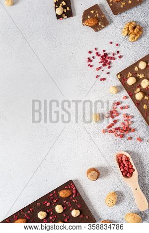 Milk And Dark Chocolate Bars With Nuts And Dried Fruits Chocolate Candies On White Background, Frame