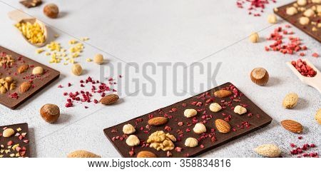 Milk And Dark Chocolate Bars With Nuts And Dried Fruits Chocolate Candies On White Background, Frame