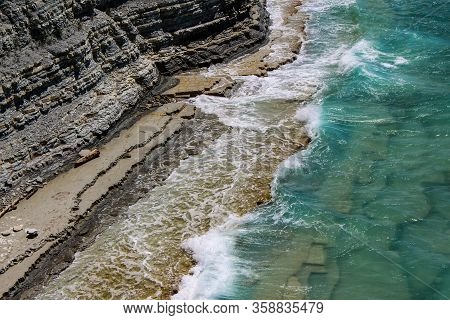 waves and rocks on a wild beach in Sosnovka camping, on the outskirts of the resort city of Gelendzhik. Black sea coast