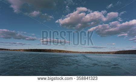 The Turquoise Sky And The Ice Of A Frozen Pond Lake