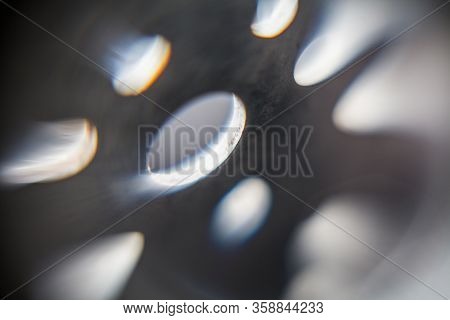 Abstract Background Depicting Metal Plate With Backlit Round Holes Of Various Sizes  Blurred And Sur
