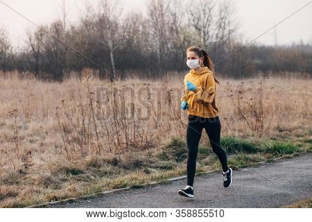 Covid-19 Pandemic Coronavirus Girl In Mask And Blue Gloves During Quarantine Went Out To Run
