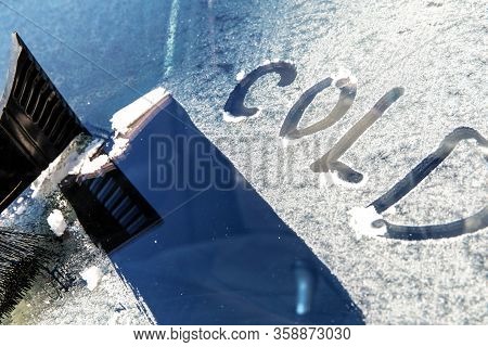 Frozen Car Windshield Covered With Ice And Snow On A Spring Day. Frosty Morning. Spring Frost On The