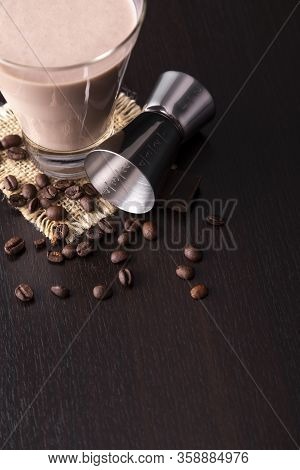 High Angle View Of Baileys Comet Cocktail Placed On A Barcounter, Decorated With Roasted Coffee Bean