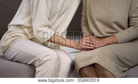 Daughter Gently Cuddling To Mother Stroking Her Caring Hands, Family Relations