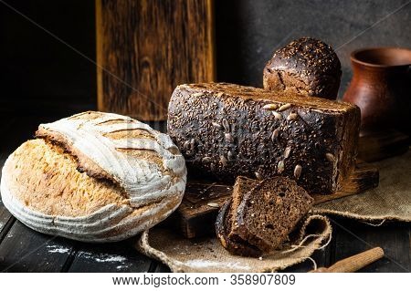 Assortment Of Baked Goods On Wood Background. Rye Bread. Wheat Bread. Vegeterain Food Concept. Sourd