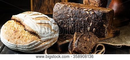 Assortment Of Baked Goods On Wood Background. Rye Bread. Wheat Bread. Vegeterain Food Concept. Sourd
