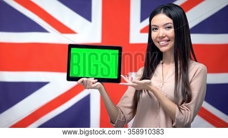 Girl Holding Tablet With Green Screen, British Flag On Background, Migration