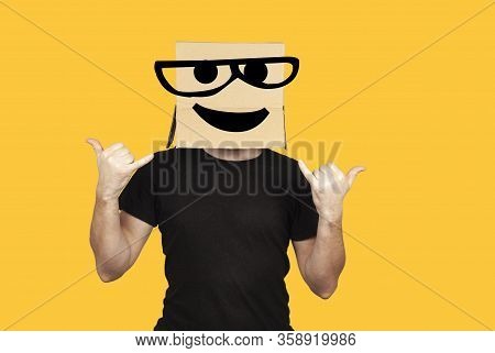 Funny Man With Box On His Head And Emoji Having Fun. Crazy Rock And Roll Party And Celebration.