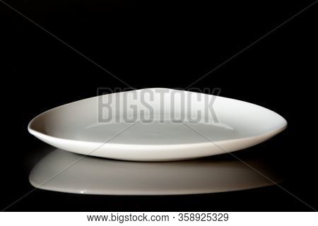 Empty White Dinner Plate On Black Background