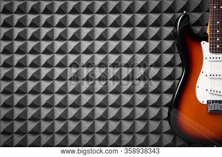 Top View Of Electric Guitar On Acoustic Foam Panel Background, Closeup