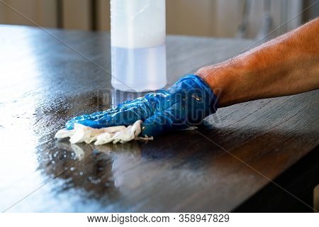 Wiping Down Surfaces And Disinfecting Table During Covid-19 Pandemic