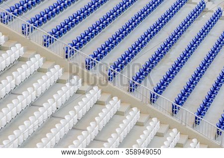 Empty Blue And White Seats In The Stadium Before The Match.