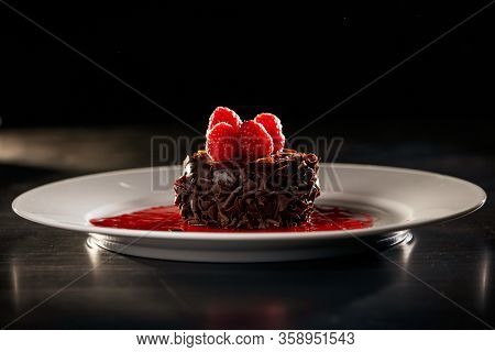 Chocolate Cupcake Dessert With Tart Raspberry Sauce
