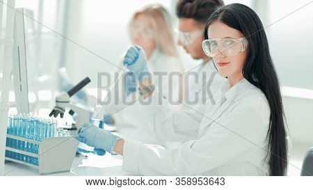 Close Up.modern Woman Sitting With Colleagues At The Laboratory
