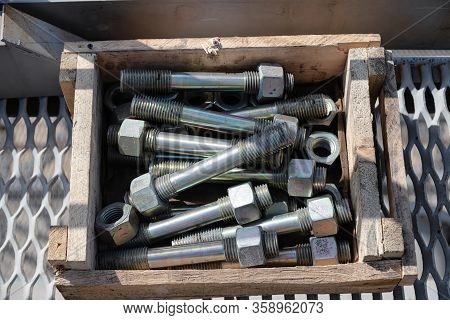 Metal Studs For Fixing Process Equipment At The Refinery Are In A Wooden Box