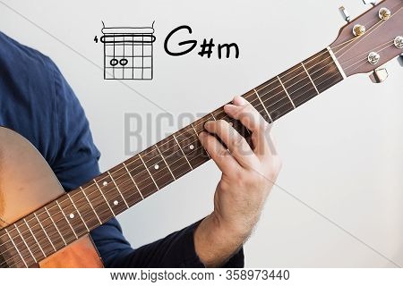 Learn Guitar - Man In A Dark Blue Shirt Playing Guitar Chords Displayed On Whiteboard, Chord G Sharp