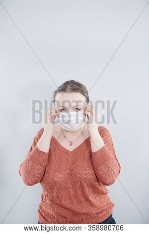 Covid-19 Pandemic Coronavirus. Close Up Of Middle Age Woman With Surgical Mask On Face Against Sars-