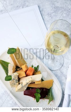 Wine Set. Assorted Cheeses. Brie, Dor Blue, Frico, Cheddar, Picorino, Ground Pear With Almonds. Whit