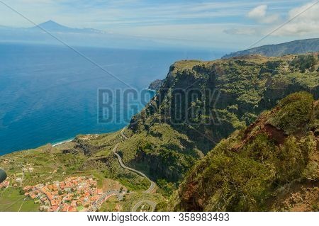 Views Of Mount Teide, A Village And A Cliff From The Glass Interior Of The Mirador De Abrante On The