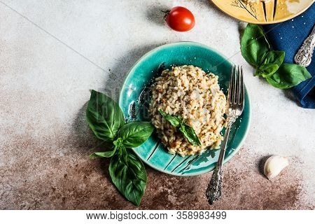 Risotto With Tomatoes On A Green Plate With Basil. Italian Food. Vegan Food Concept. Italian Cuisine