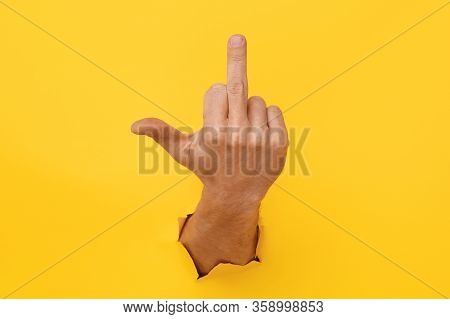 Hand On Yellow Trend Color. Torn Paper. Copy Space. Fuck.