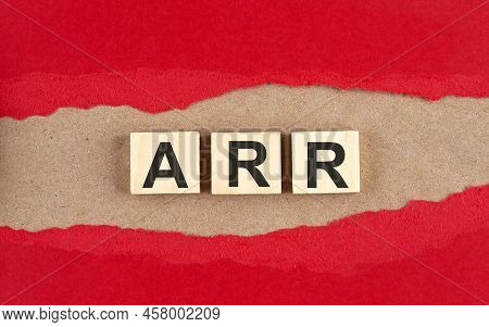 Arr Word On Wooden Cubes On A Red Torn Paper , Financial Concept Background