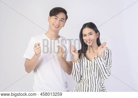 Young Smiling Man Amd Woman Holding Invisalign Braces Over White Background Studio, Dental Healthcar