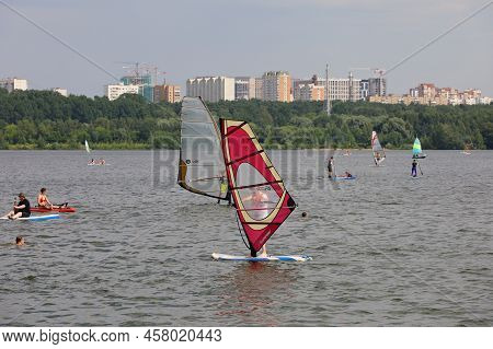 Moscow, Russia - July 2022: Sailing Yacht And People On Paddle Boards On Moscow River In Strogino Di