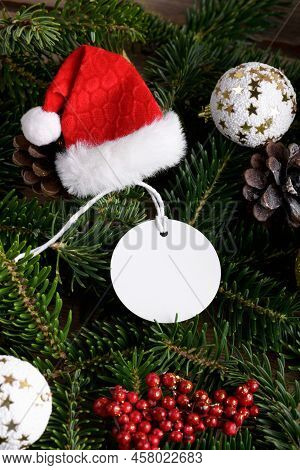 Christmas Round White Tag Mockup With White Cord, Close Up On Natural Fir Tree Branch, With Cones An