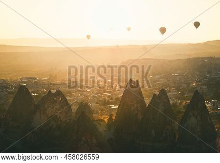 Golden Sunrise Over Goreme Town In Cappaocia Front Side Sunlight Directional With Balloons On Air In