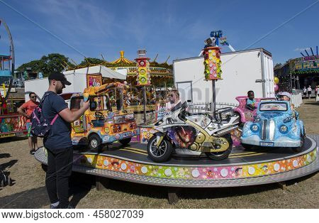 Grantham, Lincolnshire, England- July 9, 2022. Seated Carousel Lady At Grantham Wyndham Park Fair.