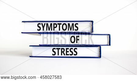 Symptoms Of Stress Symbol. Concept Words Symptoms Of Stress On Books. Beautiful White Table White Ba