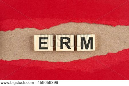 Erm Word On Wooden Cubes On A Red Torn Paper , Financial Concept Background