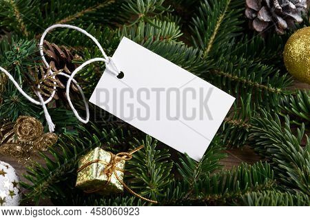 Christmas Rectangle White Tag Mockup With White Cord, Close Up On Natural Fir Tree Branch, With Cone